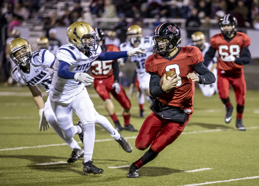 Cave Spring's (3) Lucas Duncan tries to get around Hidden Valley's (4) Jacob Pardon and (11) Cross Thompson.